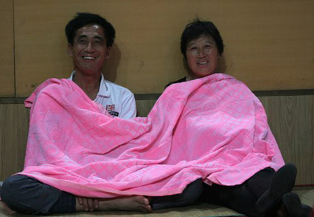 Parents of freshmen students sleep in gym