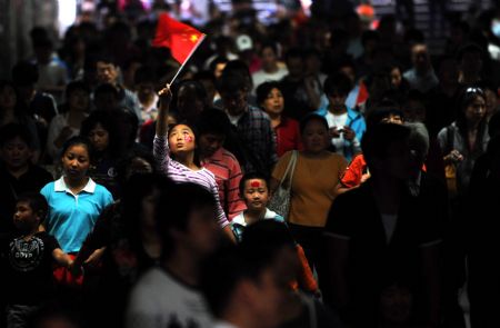 People gather at Tian'anmen Square to view floats