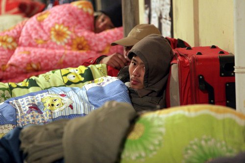 Migrant workers spend nights at temporary shelter