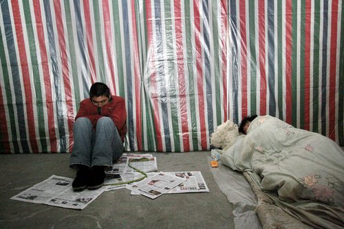 Migrant workers spend nights at temporary shelter