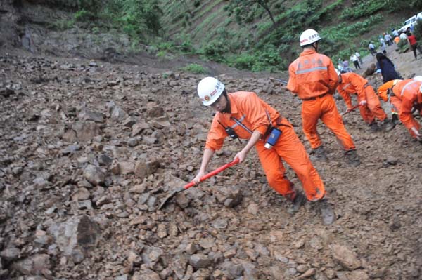 Two dead, 97 buried after SW China landslide