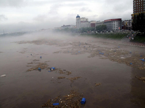 Chemical buckets washed into major river in NE China