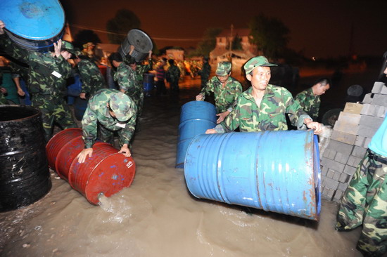 NE China province fights to contain barrels in river