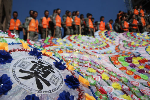 China mourns mudslide victims as relief work continues