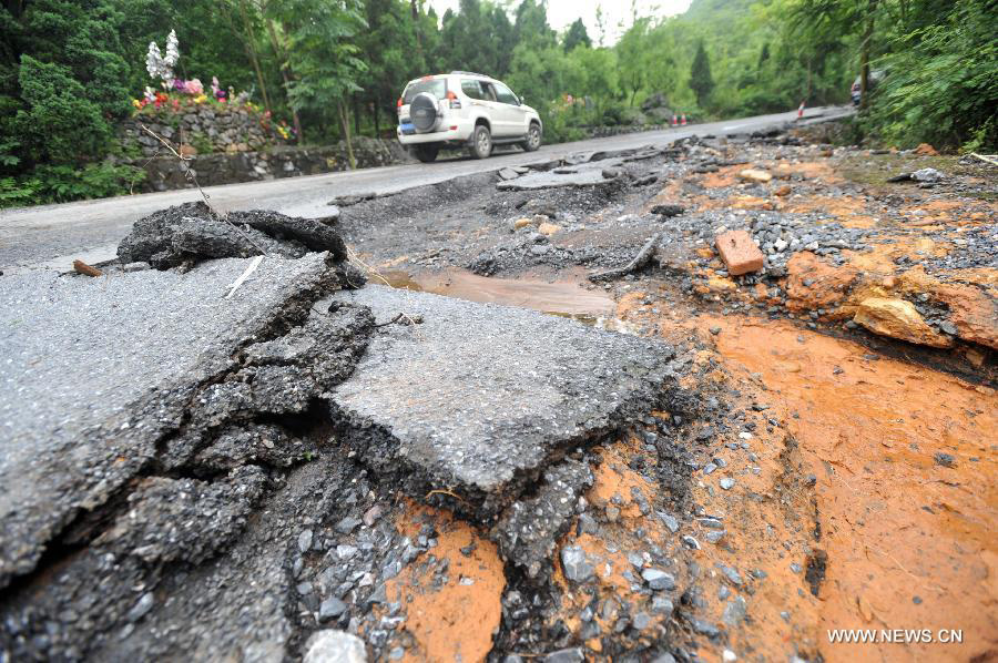 Road destroyed by rain-triggered floods in S China