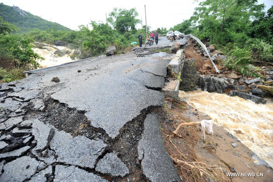 Road destroyed by rain-triggered floods in S China