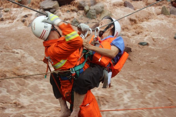 Rescuers pluck residents from raging torrent