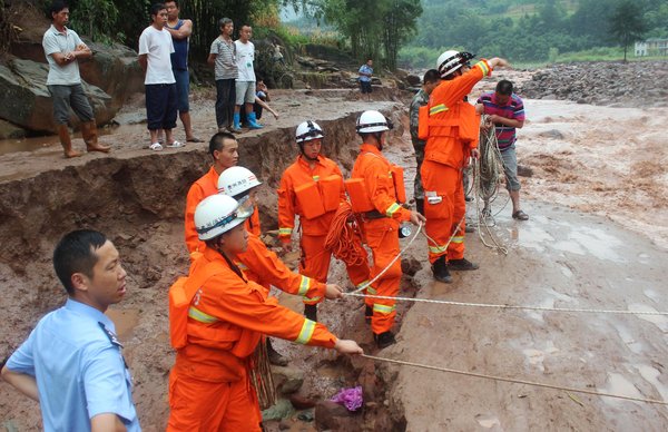 Rescuers pluck residents from raging torrent