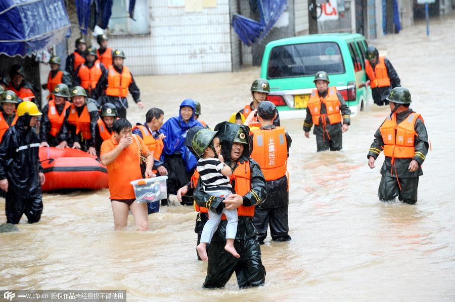 Rescuers help people flee flooding as typhoon hits Zhejiang province