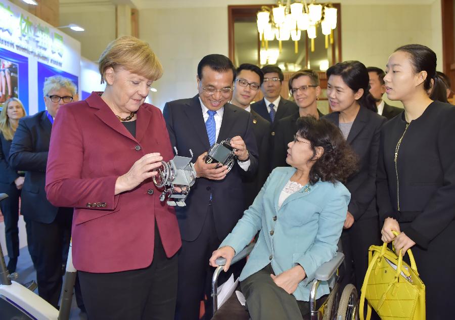 Li Keqiang, Merkel attend meeting on disability in Beijing