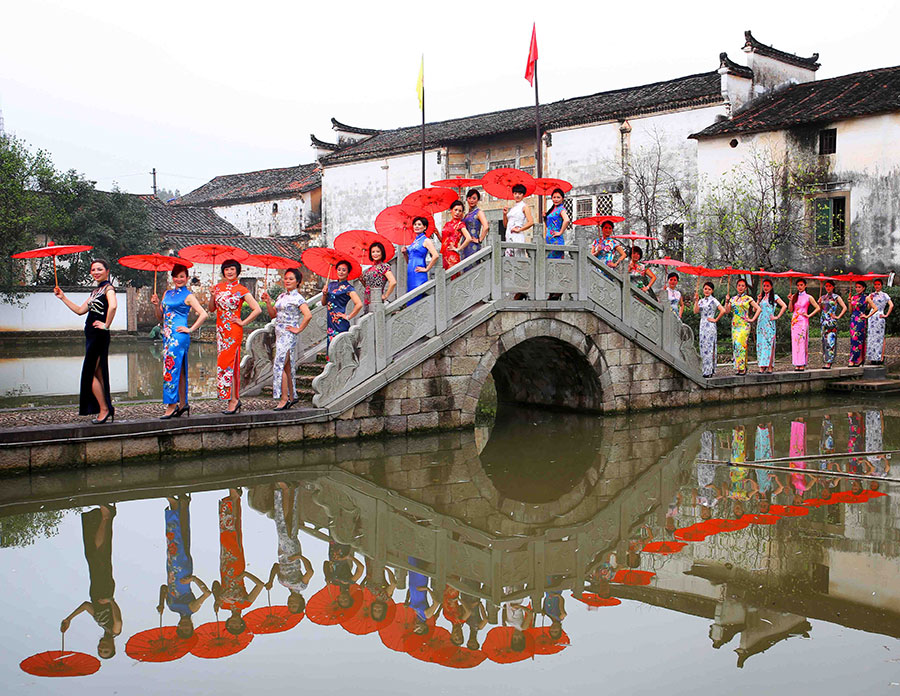 Female officials put on cheongsams to promote village