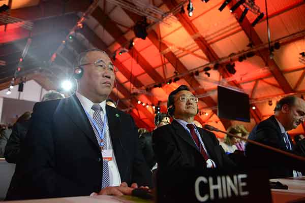 China urges implementation after historic climate deal sealed