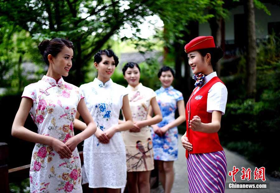 Stewardesses-to-be present traditional <EM>Qipao</EM> in SW China