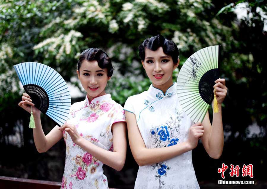 Stewardesses-to-be present traditional <EM>Qipao</EM> in SW China