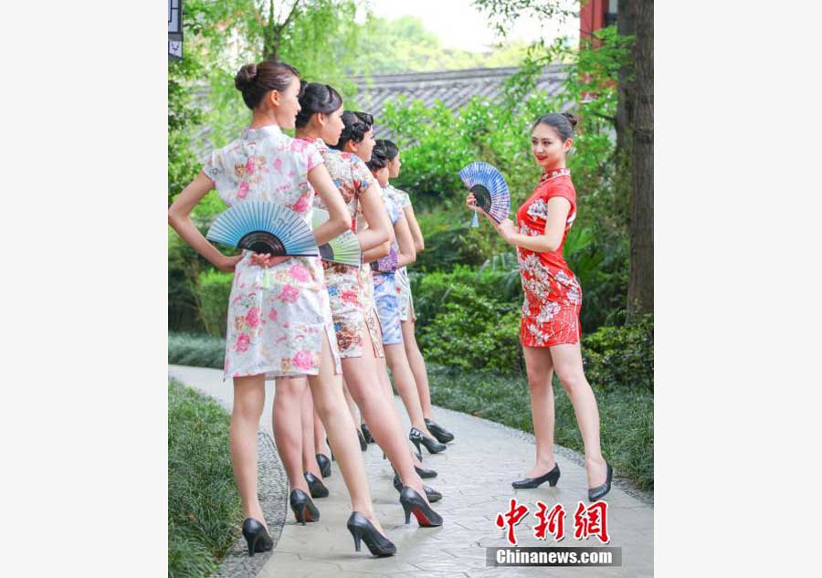 Stewardesses-to-be present traditional <EM>Qipao</EM> in SW China