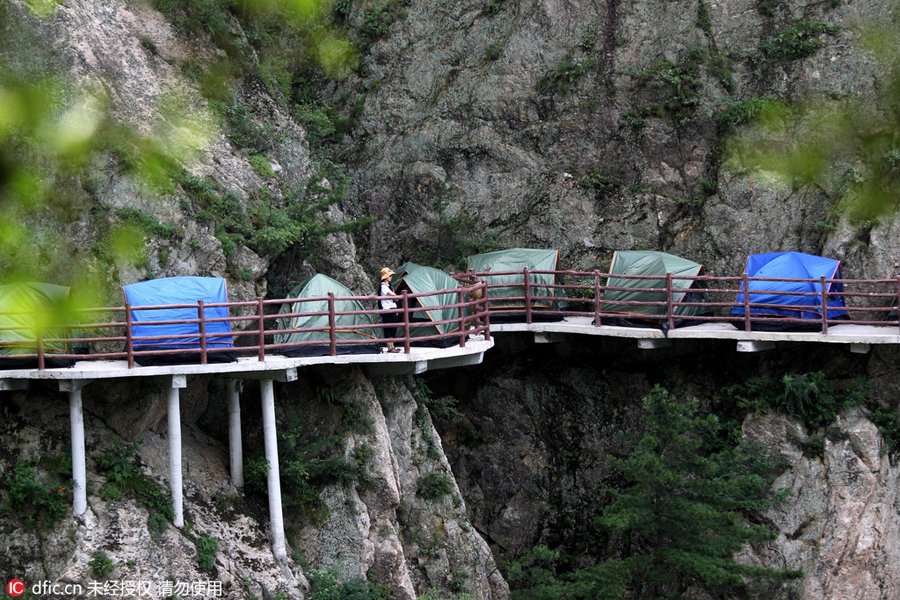 Campers sleep perched on cliff face