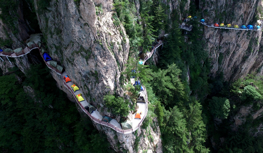 Campers sleep perched on cliff face