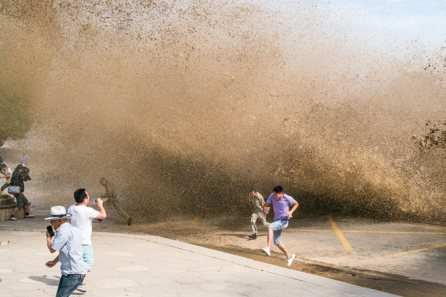 Visitors view soaring tide of Qiantang River