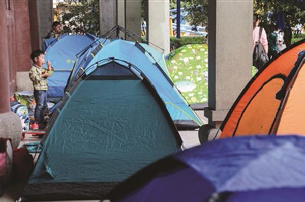 Parents camp outside youth center to stay close to children