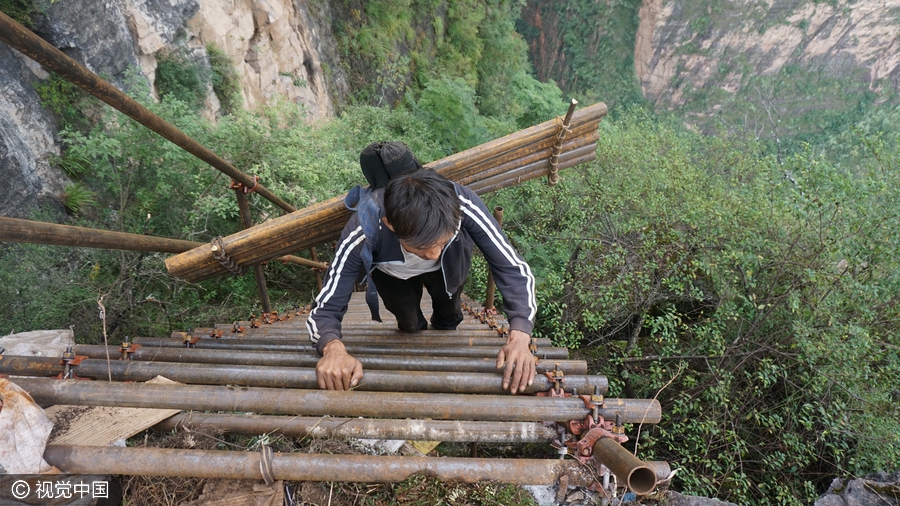 Villagers build ladder on cliff with 1,500 steel pipes