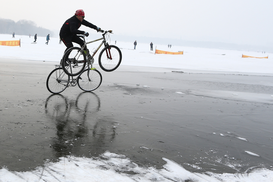 55-year-old man performs bicycle stunts on ice