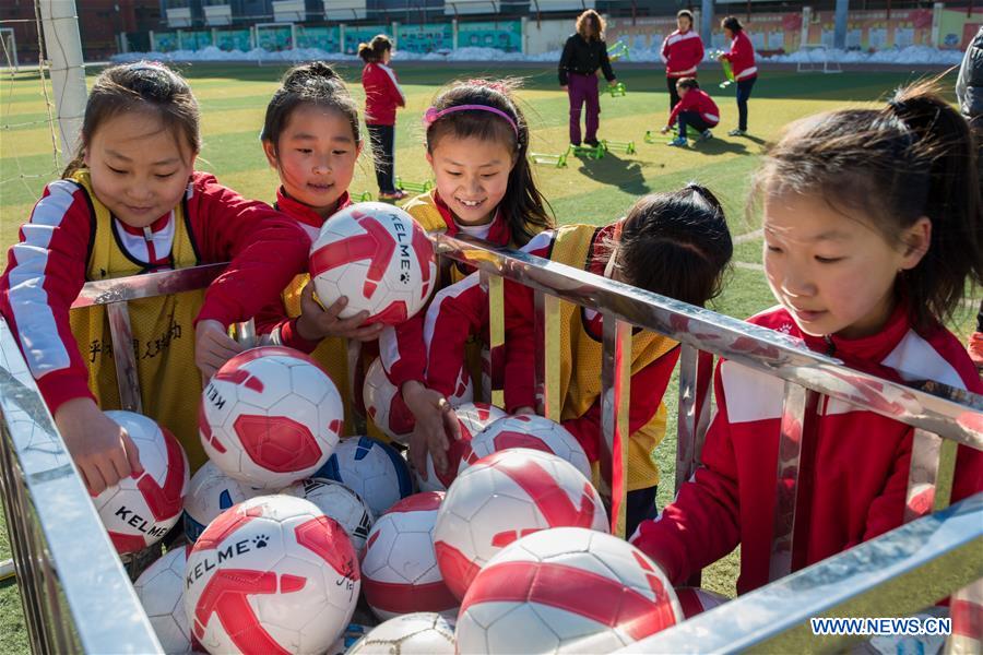 Primary school students participate in soccer training