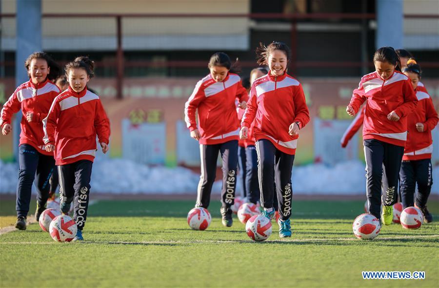 Primary school students participate in soccer training