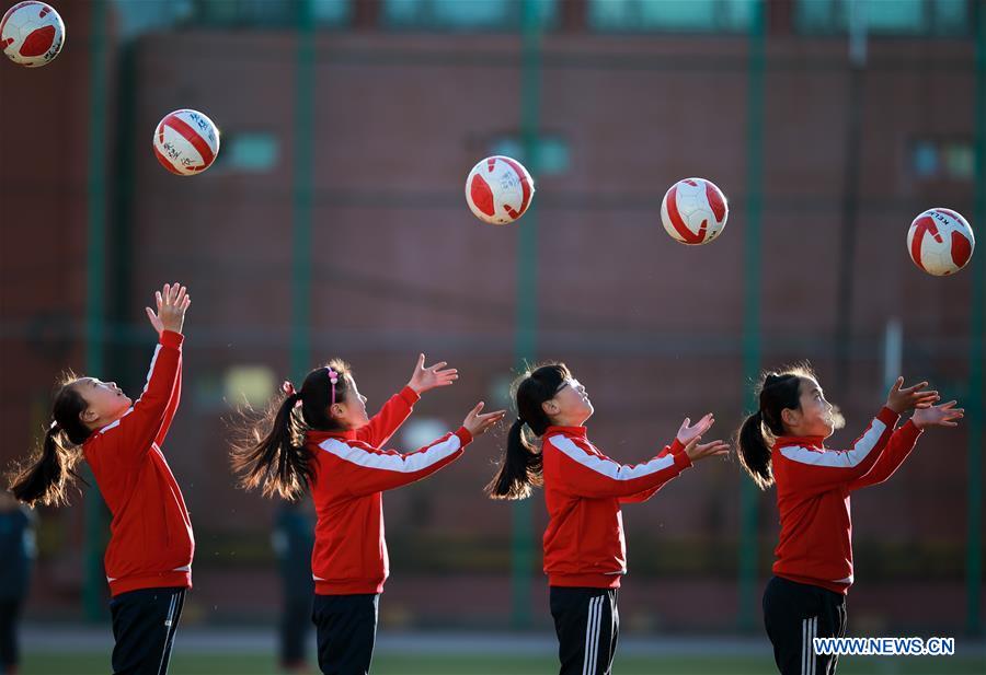 Primary school students participate in soccer training