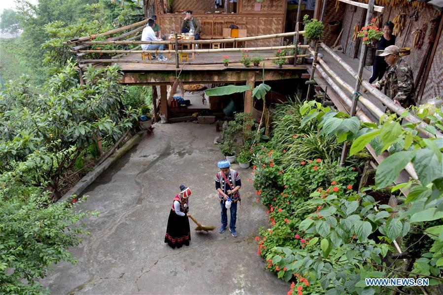 Nu ethnic couple and their family stay in SW China's village