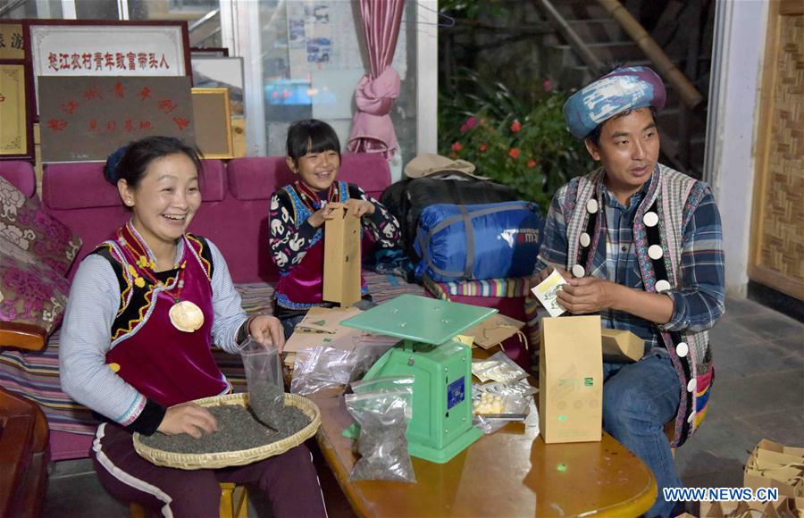 Nu ethnic couple and their family stay in SW China's village