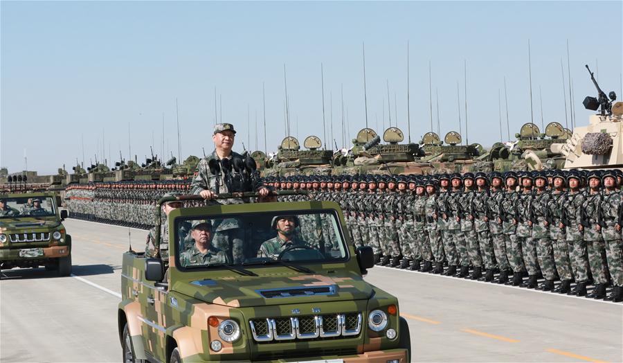 Xi reviews parade in field for first time