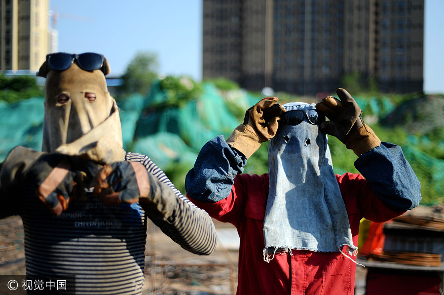 Welders cover up despite summer heat