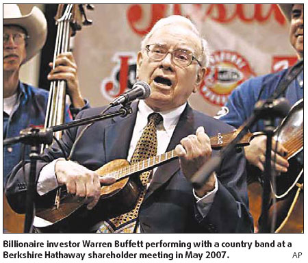 Buffett teaches young girls to play ukulele