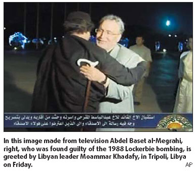 Khadafy hugs bomber; UK denies deal