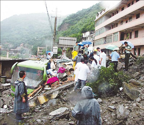 Rain-triggered landslide covers building, killing 18