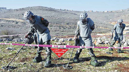 Chinese soldiers clear mines, win hearts