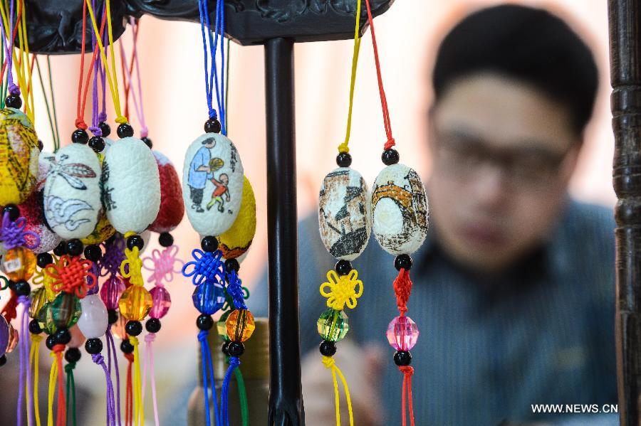 Art teacher creates unique paintings on silkworm cocoons