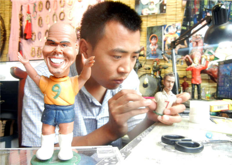 Artist creates dough figurine football stars