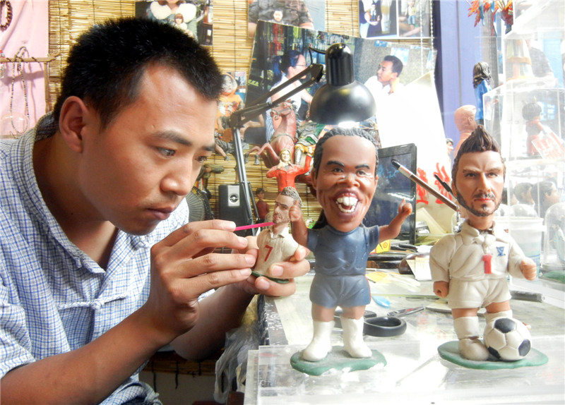 Artist creates dough figurine football stars