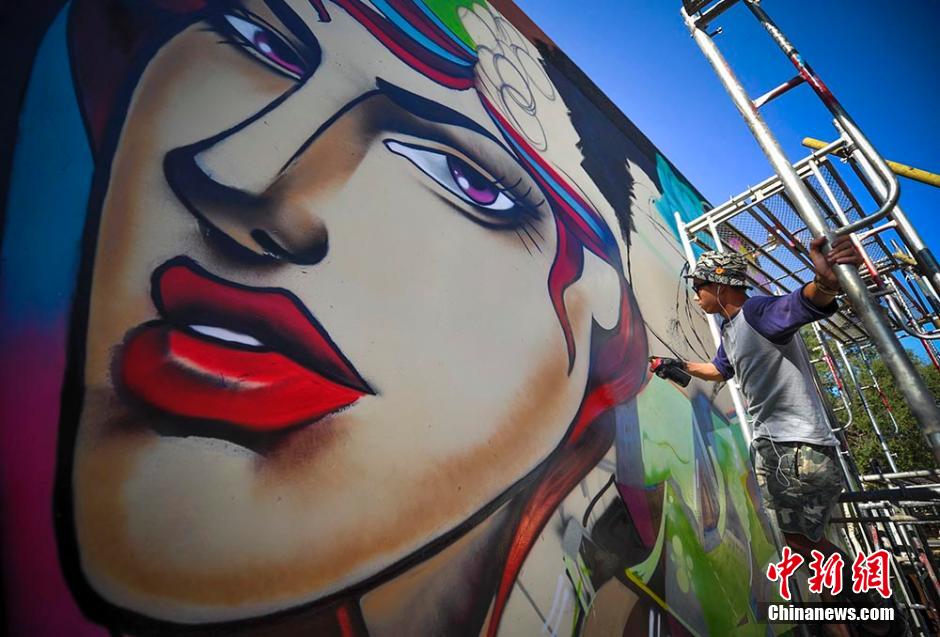 Graffiti artists paint on street walls in Xinjiang