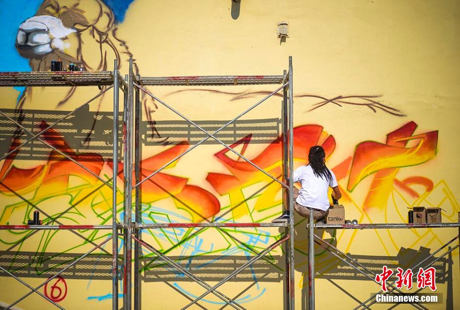 Graffiti artists paint on street walls in Xinjiang