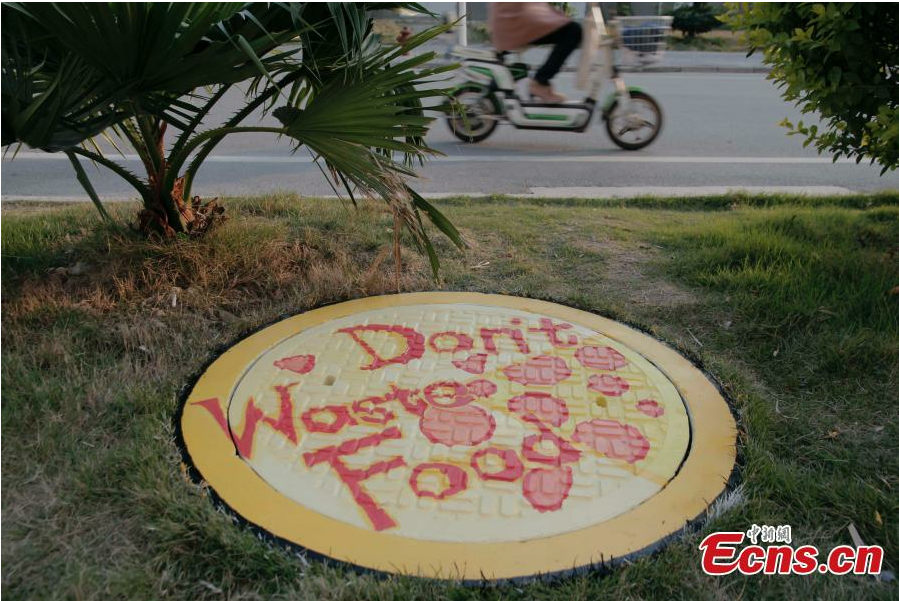 Students paint dream on manhole covers