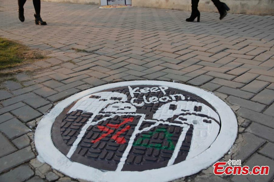 Students paint dream on manhole covers