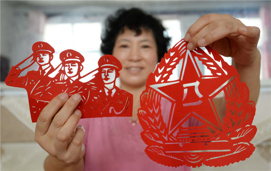 Artist creates paper-cuts to mark PLA's 90th anniversary