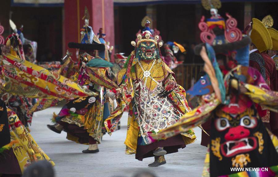 Tibetan Buddhist monks perform to greet Tibetan New Year