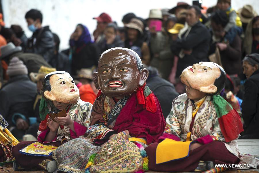 Tibetan Buddhist monks perform to greet Tibetan New Year