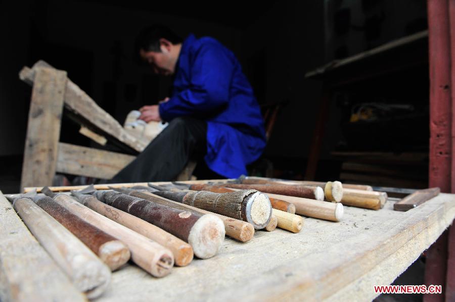 Folk artisan works on Nuo Opera masks