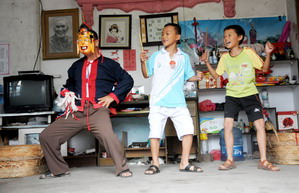 Folk artisan works on Nuo Opera masks