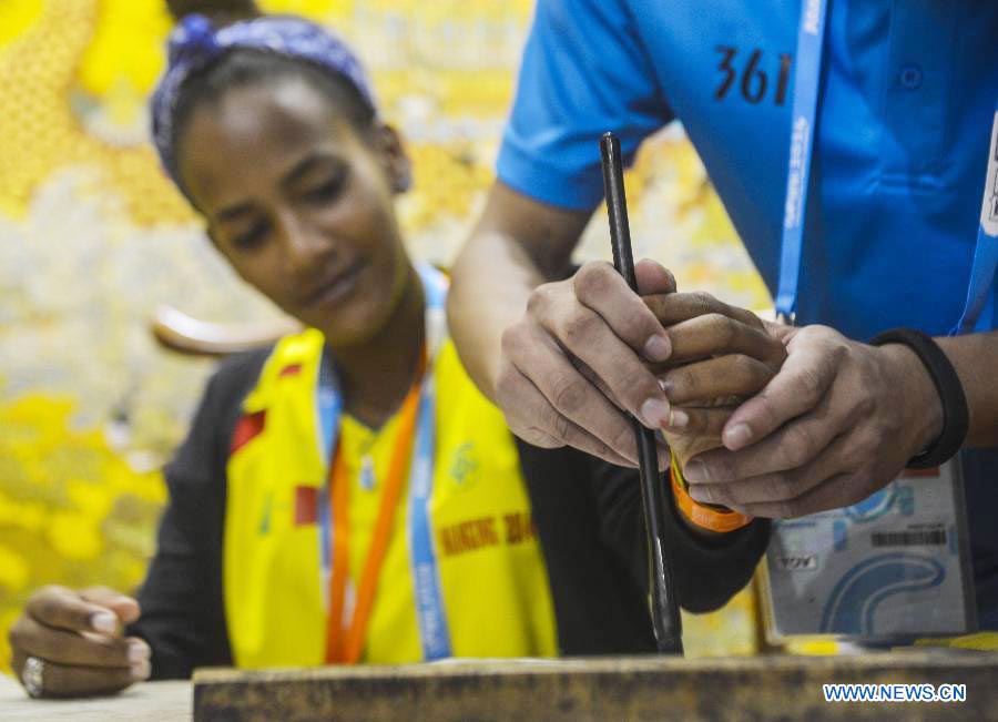 Athletes practice calligraphy at Youth Olympic Village