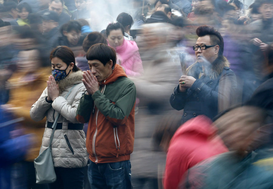 People pray on the first day of Chinese New Year